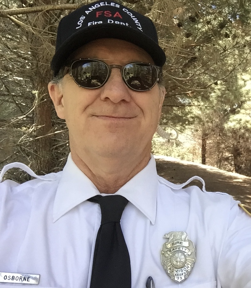Mr. Osborne in a fire prevention uniform with badge, name plate, L. A. County Fire ball cap and cool looking sunglasses. Mr. Osborne looks classy in his uniform! Ha ha!