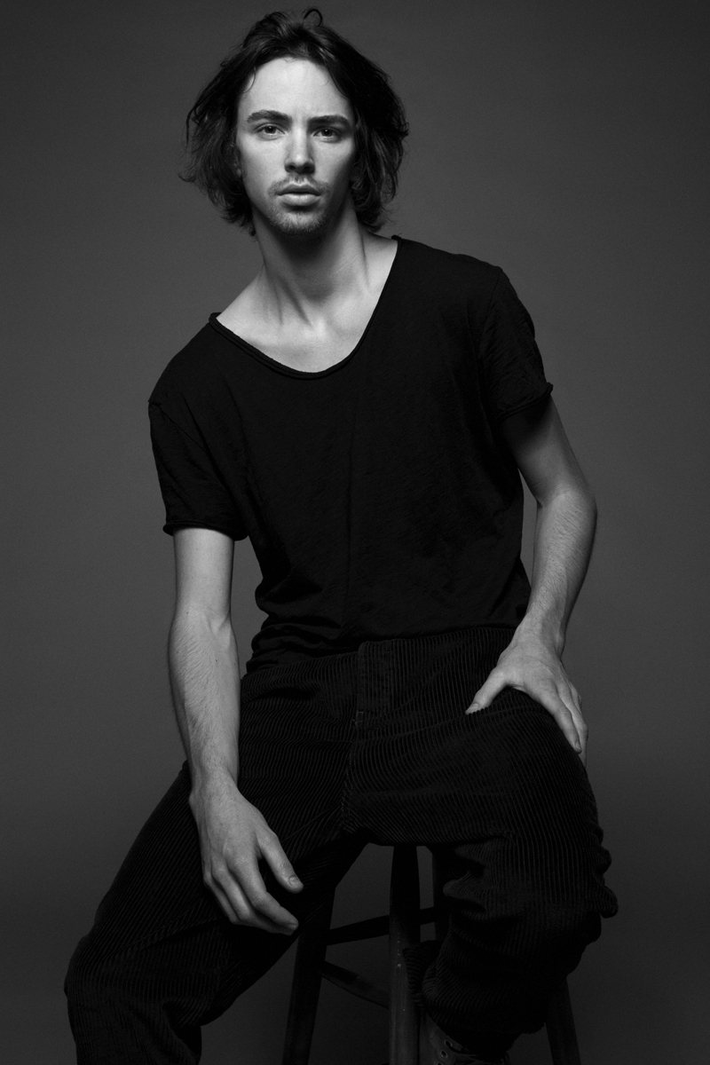 Black and White Portrait of Photography Instructor Geir Foshaug sitting on a chair