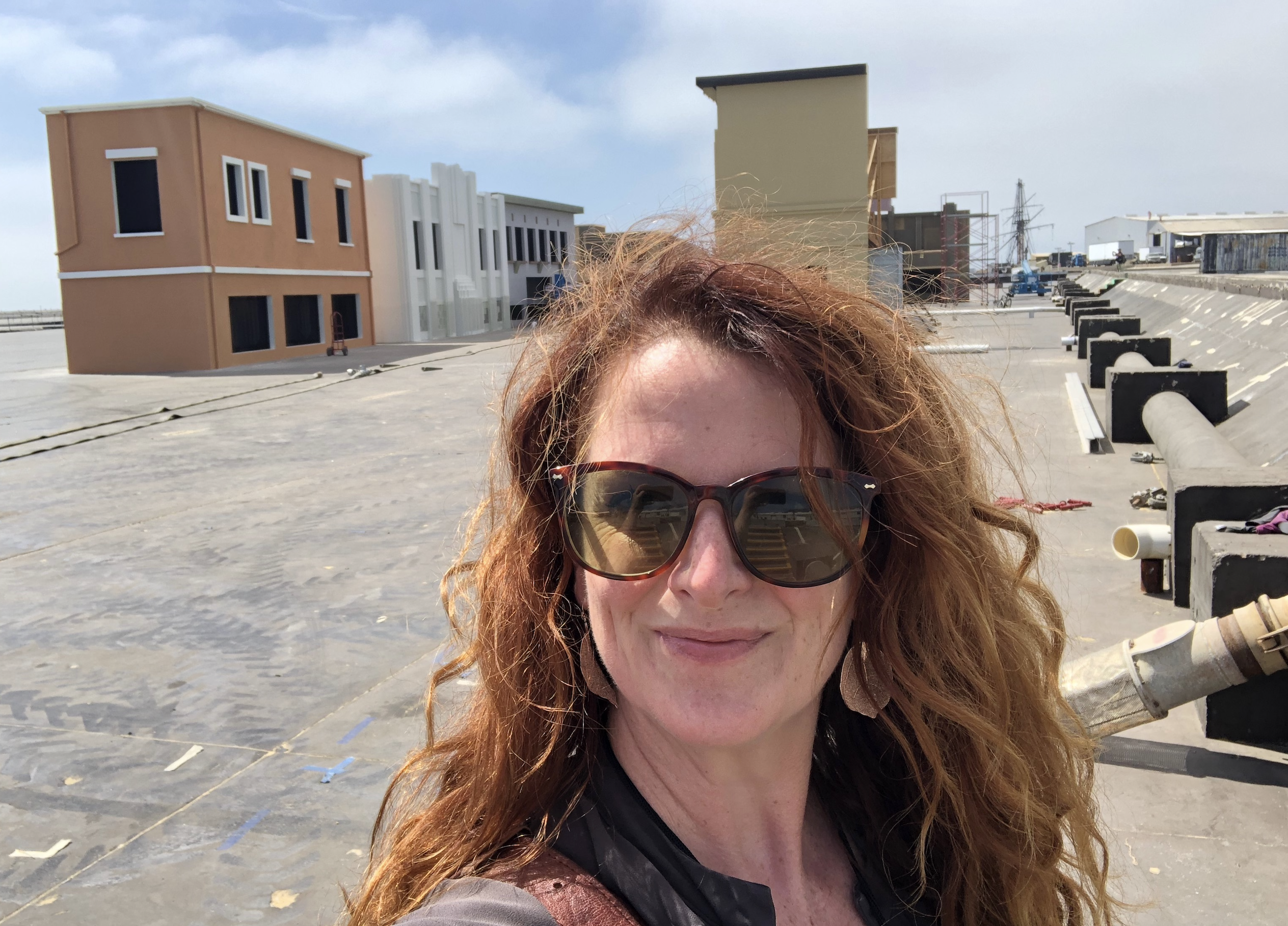 Ms. Clancy in the dry tanks in Mexico with a set build behind her