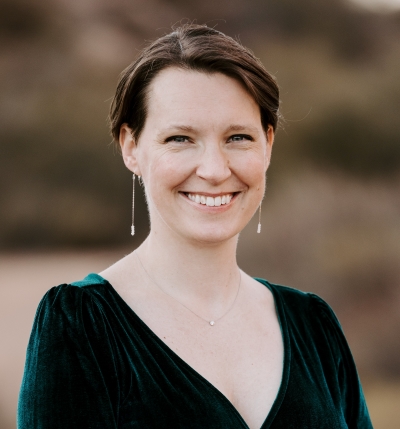 Photo of Dr. Erica Seubert, she is a white woman with short brown hair and blue eyes smiling at the camera