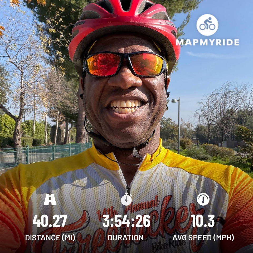Tony Sipp wearing a red helmet in a bicycle jersey with the word."Firecracker".