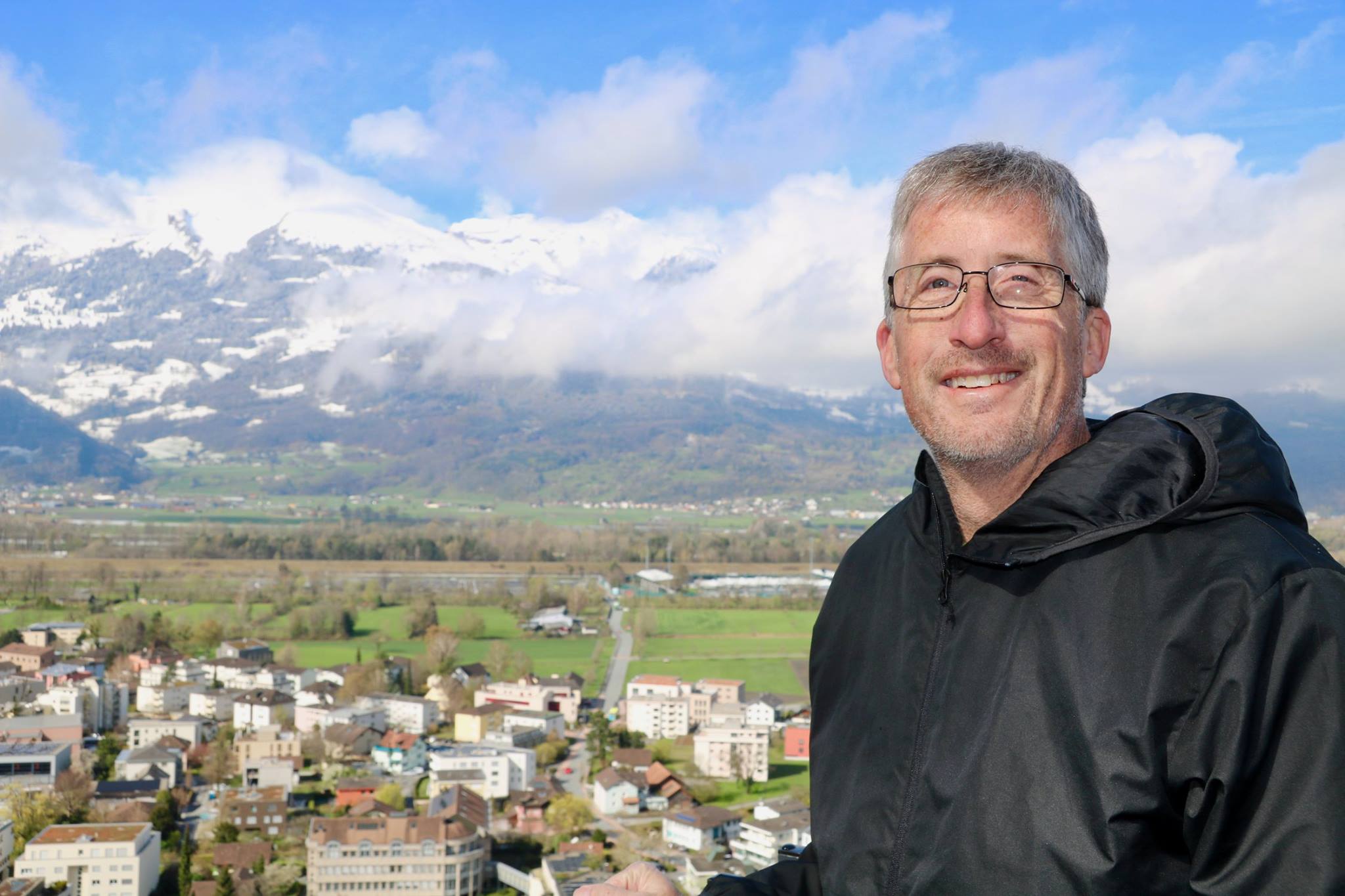 Dave Brill smiling with European Alps in background