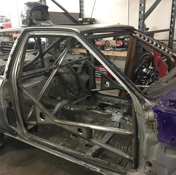 Rusty old Corolla with a roll cage